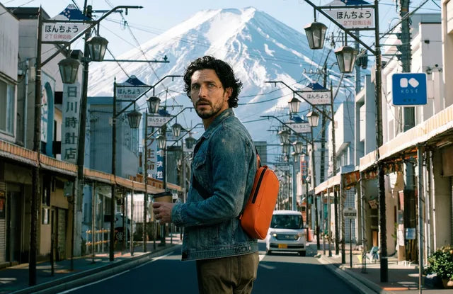 Traveler wearing the Meetnex chest bag on a city street